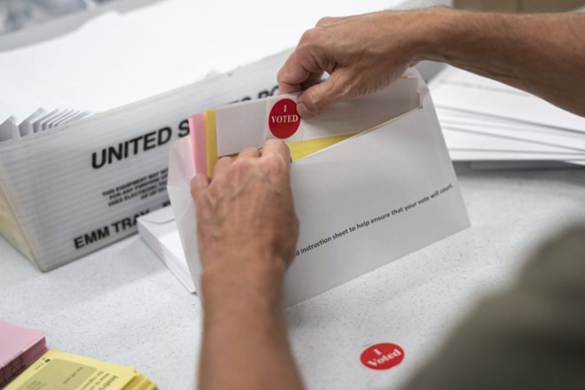 Todd Gallagher prepares mail-in ballot envelopes including an "I voted" sticker in Minneapolis in July. Absentee ballots are being requested at a record level this year. Nearly 470,000 Minnesotans have requested to vote absentee. That's 12 times the number requesting mail-in voting at this point in 2018. This year's demand obliterates the demand in the 2016 Presidential election, when only 20,000 absentee ballots were requested by July 24.GLEN STUBBE – STAR TRIBUNE