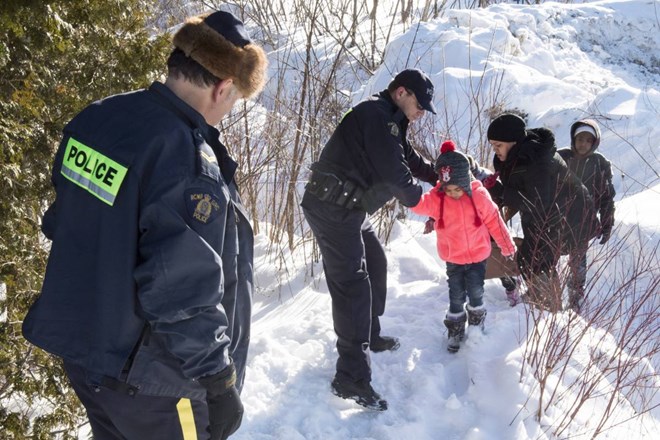 With Open Arms Mounties Help Refugees Who Walked Across The Canadian Border