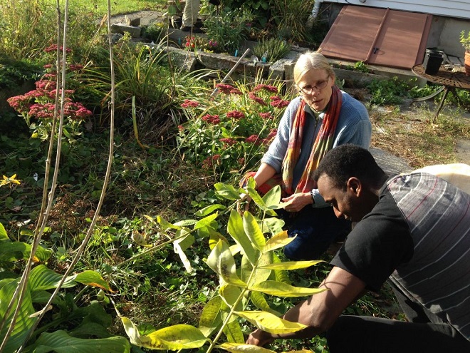 Abdi and Sharon McDonnell weed in McDonnell’s North Yarmouth garden. McDonnell first reached out to Abdi after hearing one of his radio broadcasts from Somalia in 2009.