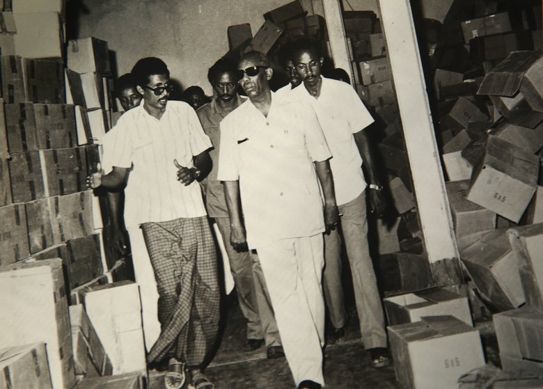 (Photo courtesy of Abdulkadir Aden Mohamud) Abdulkadir Aden Mohamud, also known as “Jangeli,” left, walks with former Somali President Siad Barre while Mohamud worked as the general manager of a fruit-processing factory in Somalia in 1982. Mohamud later became head of Somalia’s development bank.