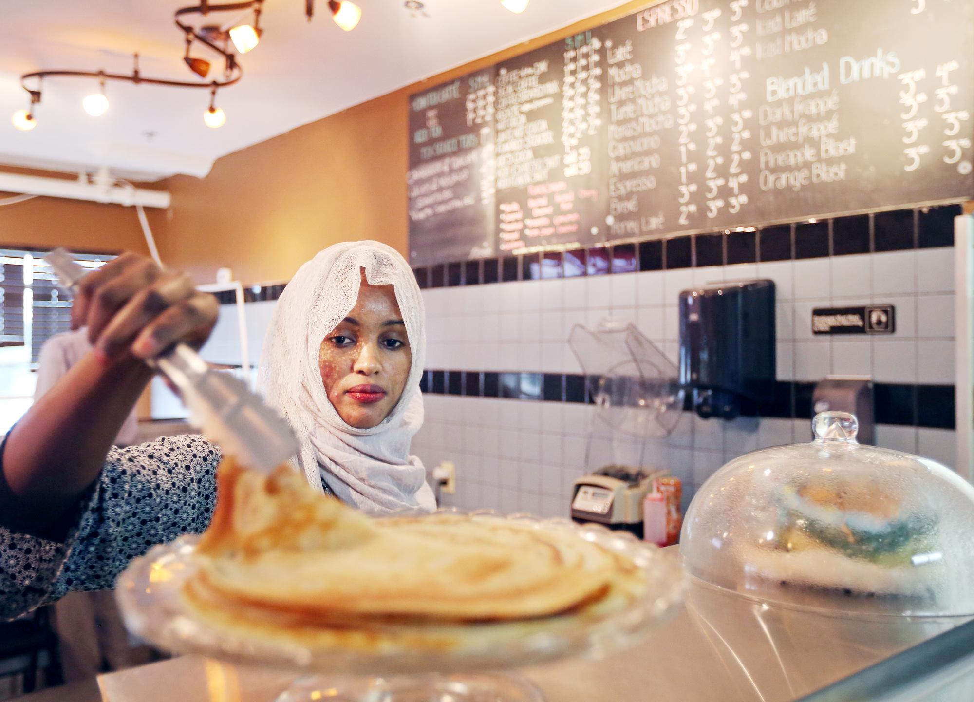 Bulbulo Mohamud lifted a piece of malawax (similar to a pancake) for a customer at her cafe.