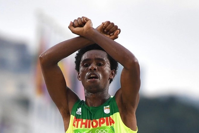Ethiopia's Feyisa Lilesa crosses his arms above his head at the finish line of the Men's Marathon athletics event of the Rio 2016 Olympic Games. (Olivier Morin/AFP/Getty Images)
