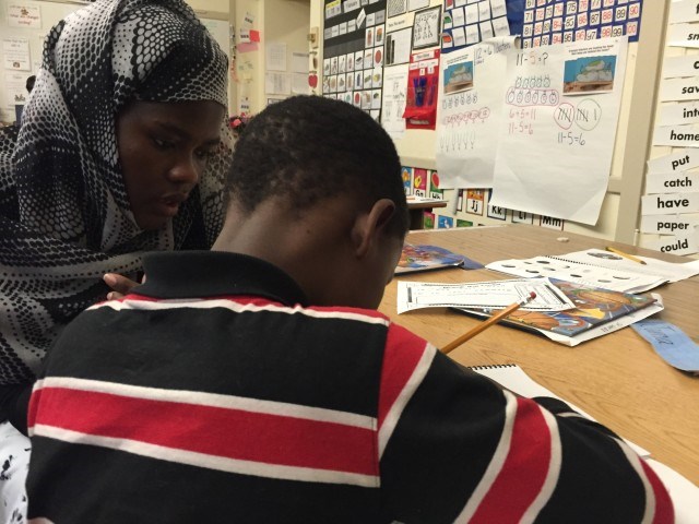 Educational assistant, Batula Mohamud, works with a first-grader she knows from Portland's Somali community. Rob Manning/OPB