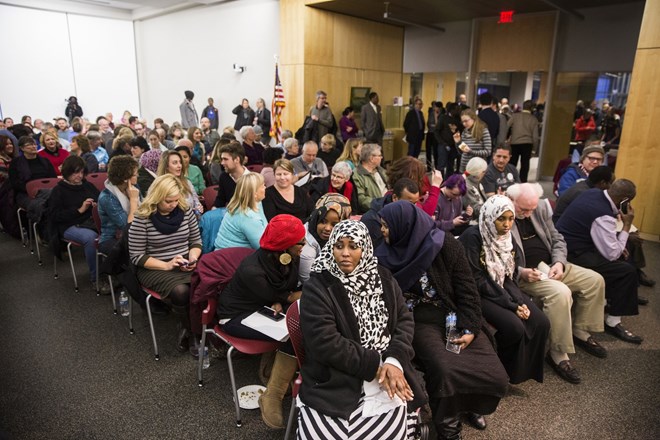 Lul Hersi, center front, a Somali-American and community advocate in St. Cloud, waits in the audience to sit on the panel of a forum discussion entitled "Muslims in Minnesota: A community conversation" held by Minnesota Public Radio at St. Cloud Library on Thursday, January 28, 2016. Photo by: LEILA NAVIDI