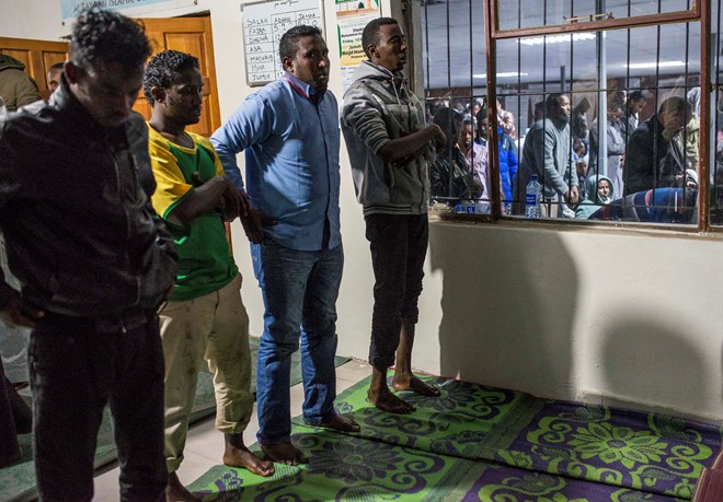 Somali migrants at prayer after the ending of the day's fast