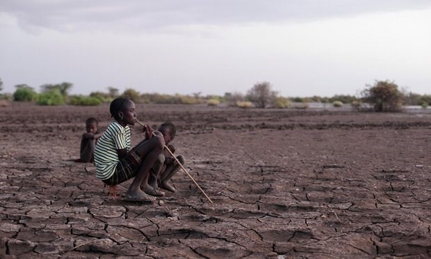 Children sitting on the Omo river bank, which is cracked due to falling water levels. Photograph: Alamy