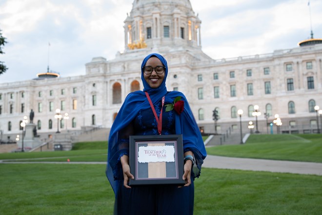 Qorsho Hassan, Minnesota's 2020 Teacher of the Year, holds her makeshift award in front of the state Capitol Thursday night. The frame will be replaced with an engraved plaque. Credit: Jaida Grey Eagle | Sahan Journal