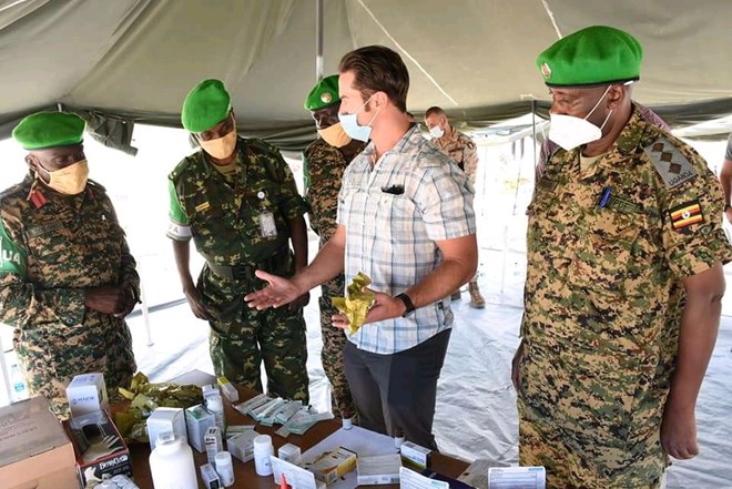US civil affairs team to sector one anti-aircraft asset commander Col Ismail Sendagire handing over the donations to the officers (PHOTO/Courtesy).