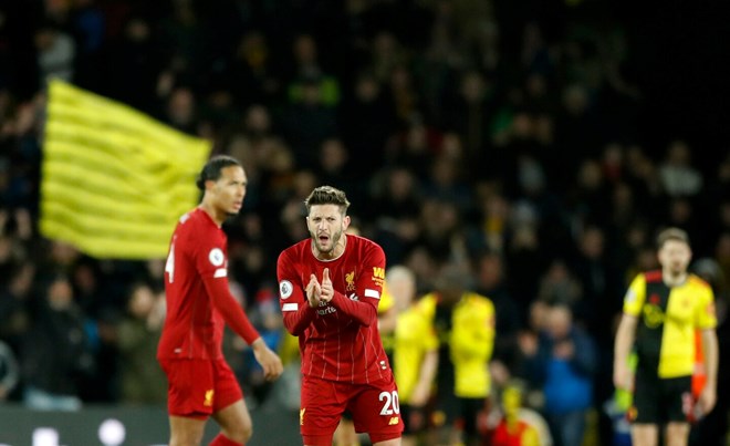 Liverpool’s Adam Lallana, center, reacts after Watford’s Troy Deeney scores his side’s third goal during the English Premier League soccer match between Watford and Liverpool at Vicarage Road stadium, in Watford, England, Saturday, Feb. 29, 2020. (Alastair Grant/Associated Press)