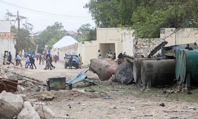 Police survey the scene after a suicide car bomber drove into a checkpoint near the port in Mogadishu. Photograph: Feisal Omar/Reuters