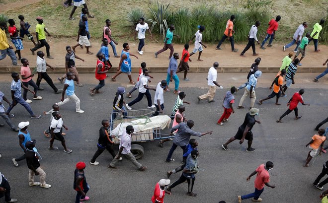 Protesters marched in Nairobi on Monday with the body of a man they claimed had been beaten to death by the police for violating curfew.Credit...Brian Inganga/Associated Press