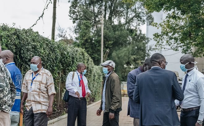 Members of the Ministry of Health outside of the Kenya Medical Training College, where suspected coronavirus patients are being quarantined, in Nairobi, Kenya, on Wednesday.Credit...Khadija Farah for The New York Times