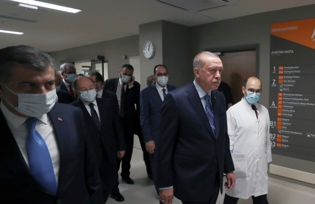 In this photo provided by the Turkish Presidency, Turkey's President Recep Tayyip Erdogan, front center, arrives to attend the inauguration ceremony for Basaksehir Pine and Sakura City Hospital, in Istanbul, Thursday, May 21, 2020.