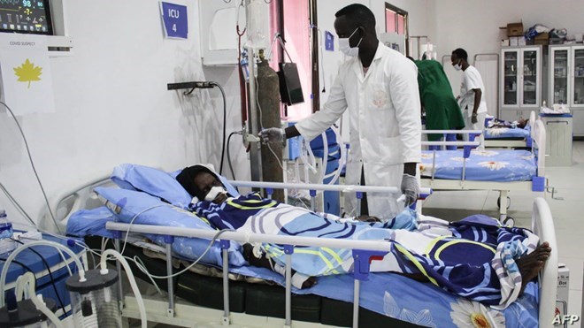 FILE - A doctor cares a patient who is infected with the COVID-19 in the Intensive Care Unit at Martini hospital in Mogadishu, Somalia, July 29, 2020.