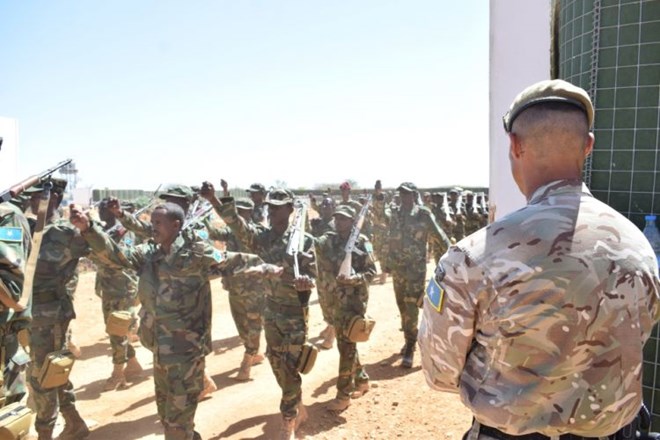Soldiers and officers from 8 Brigade, Somalia National Army marching past a UK instructor during their graduation ceremony in Baidoa, Somalia (Picture: MOD).