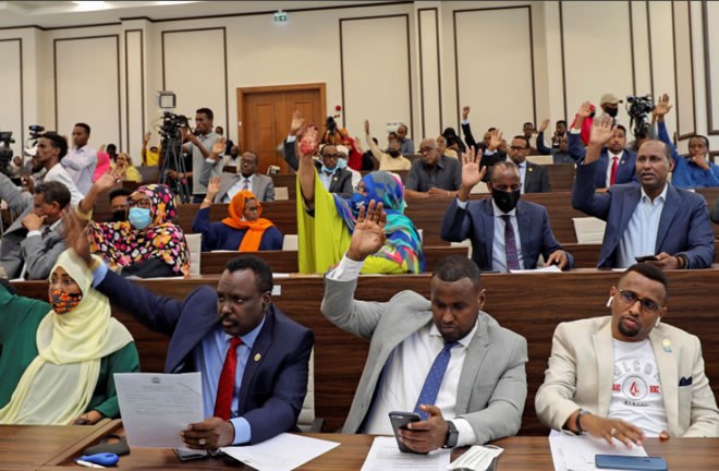Somalia legislators vote by rising their hands to cancel a divisive two-year presidential term extension, inside the lower house of Parliament in Mogadishu, Somalia May 1, 2021. REUTERS/Feisal Omar