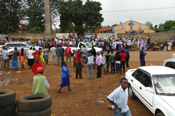 Worshippers mill outside the Holy Rosary Kutus Catholic Church in Kirinyaga County after they discovered a bomb inside the church.Local security officers have cordoned off the church until bomb experts arrive from Nairobi to detonate the explosive. PHOTO | GEORGE MUNENE