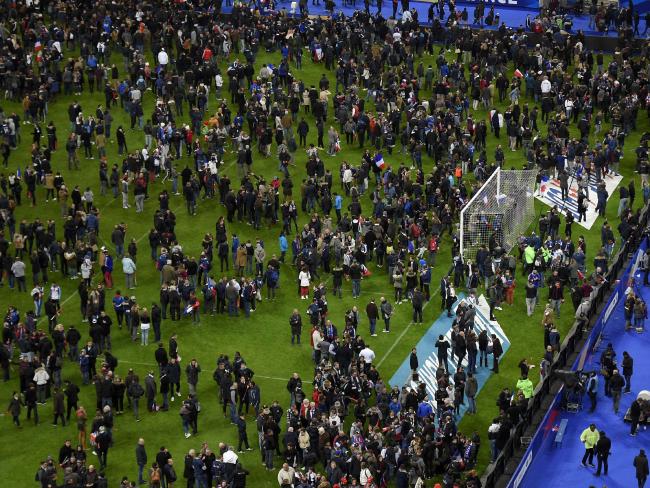 Football fans gather in the field as they wait for security clearance to leave the Stade de France. AFP/Frank Fif.Source:AFP