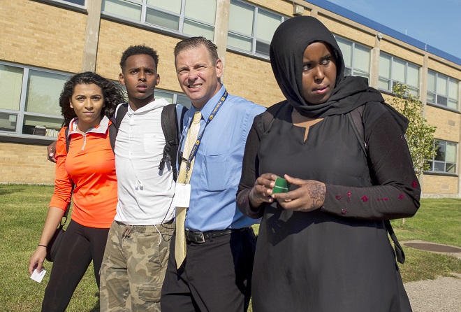 From left, Sherouk Mohamed, Karim Muse, Principal Dan Wrobleski and Khadra Mohamed returned to Columbia Heights High School after a protest. (RICHARD TSONG-TAATARII)