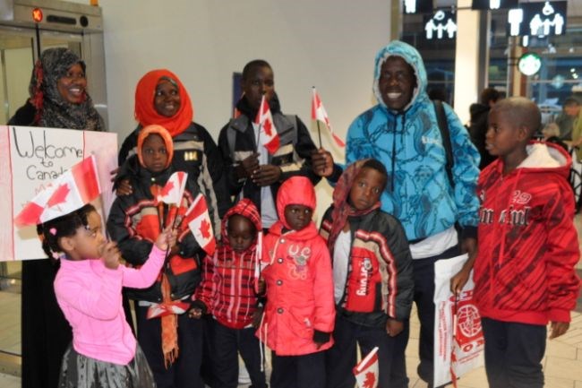 Children mingled as the new Somali refugees posed for a photo prior to their luggage arriving.