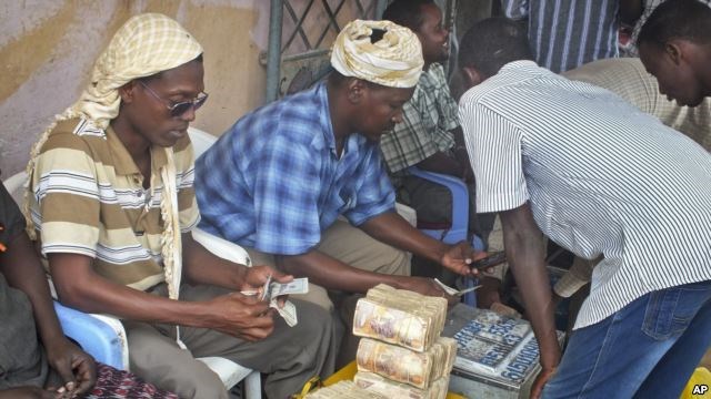 A customer of Dahabshiil, a Somali remittance company, exchanges U.S. dollars for Somali shillings outside the company's headquarters in Mogadishu, Somalia.