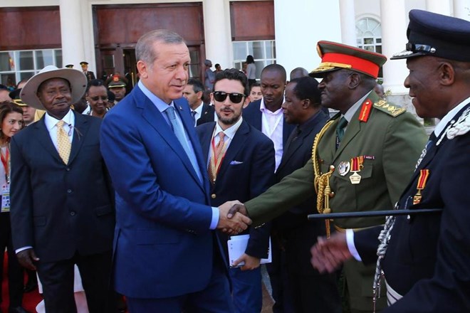 Uganda's long-time president Yoweri Museveni, left, watches as Turkey's President Recep Tayyip Erdogan shakes hands with Ugandan military generals during a welcome ceremony in the capital Kampala, Uganda, Wednesday, June 1, 2016. Museveni was sworn in earlier in May for a fifth term taking him into his fourth decade in power, amid arrests of opposition politicians and a shutdown of social media. Erdogan is on a two-day state visit.(Kayhan Ozer, Presidential Press Service/Pool via AP) THE ASSOCIATED PRESS