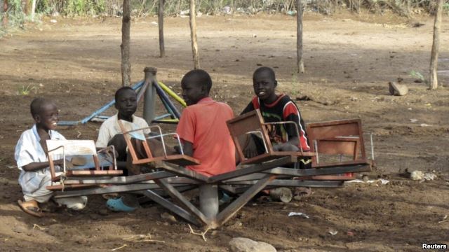 FILE - Children play with a broken playground chair in Kakuma refugee camp in northwestern Kenya.
