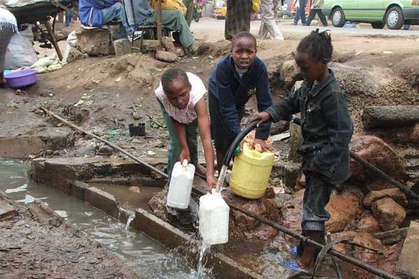 Children fetch water from a burst pipe in Mathare, Nairobi. Many city residents will be slapped with higher water bills after the Nairobi City Water and Sewerage Company raised its rates. FILE PHOTO | NATION MEDIA GROUP