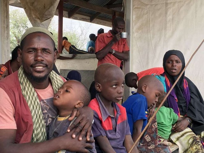 A Somali family waits to board a bus that will take them back to Somalia from the Dadaab refugee camp on January 21 in a voluntary repatriation programme /REUTERS