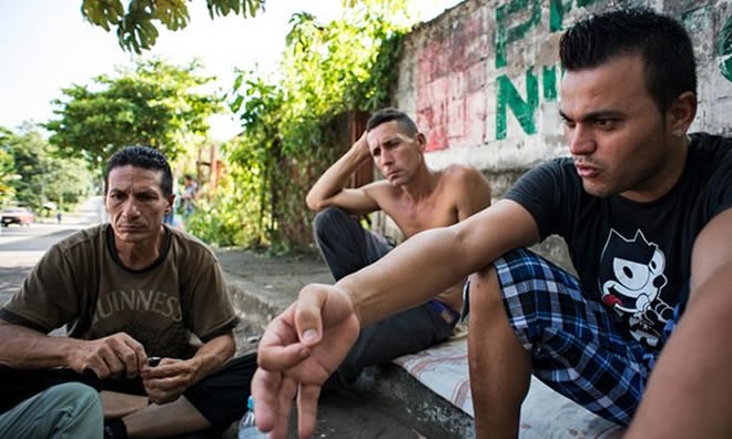 Ernesto Pérez, left, and Onel Martín sailed seven days on a handcrafted boat in Mexico. Junior Bordon flew to Guyana and travelled on foot, bus and boat to Mexico. Photograph: Encarni Pindado for the Guardian