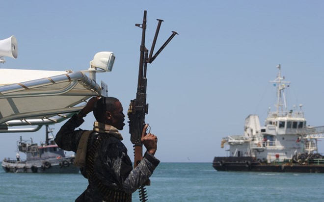 A maritime policeman guarded an oil tanker after its release. Somali pirates have hijacked four ships in the past month.