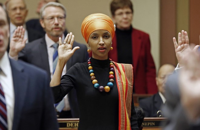 State Rep. Ilhan Omar takes the oath of office in 2017. Jim Mone / AP