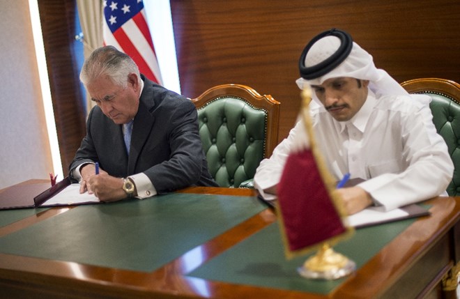 In this Tuesday July 11, 2017 photo U.S. Secretary of State Rex Tillerson, left, and the Qatari Minister of Foreign Affairs Sheikh Mohammed bin Abdulrahman Al Thani sign an memorandum of understanding in Doha, Qatar. Tillerson arrived in Qatar as he tries to mediate a dispute between the energy-rich country and its Gulf neighbours. (Alexander W. Riedel/US State Department via AP)