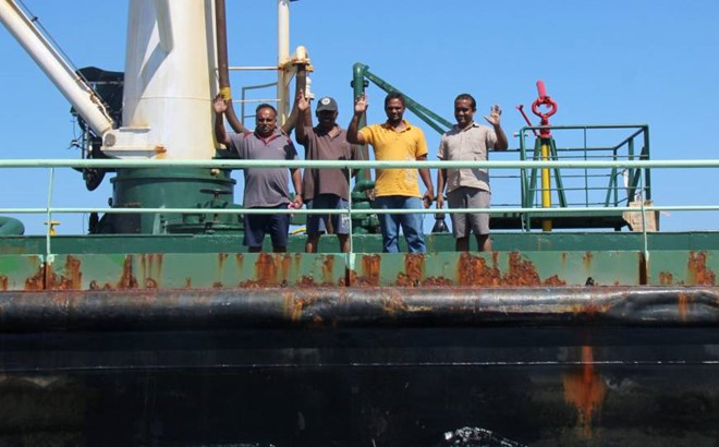 Crew members are seen aboard the oil tanker Aris-13, which was released by pirates, as it sails to dock on the shores of the Gulf of Aden in the city of Bosasso, northern Somalia's semi-autonomous region of Puntland, Sunday. | REUTERS