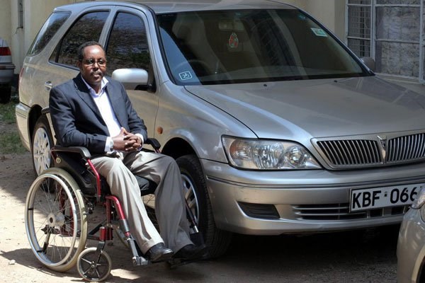 Harum Hassan poses for a photo next to his car in Pangani on December 22, 2009. He is a spinal cord injury victim. PHOTO | PHOEBE OKALL | NATION MEDIA GROUP