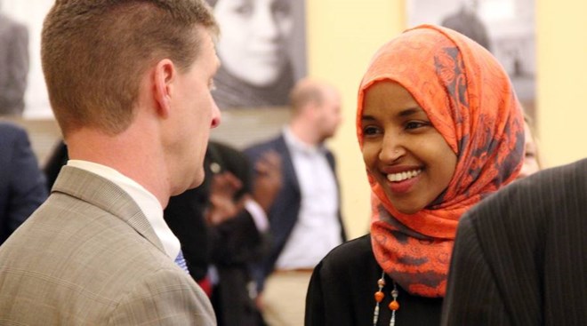 Shep Harris, left, a lobbyist hired by the Coalition of Somali American Leaders, speaks with state Rep. Ilhan Omar in St. Paul, Minnesota. - Laura Yuen | MPR News