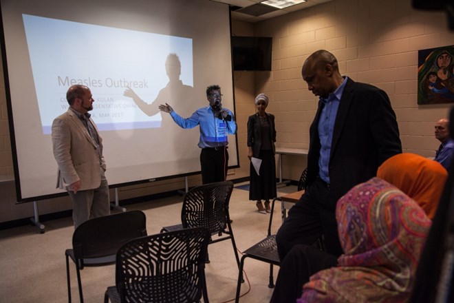 Abdirizak Bihi translates for Ilhan Omar at her event in Brian Coyle Community Center in Minneapolis on May 17, 2017.