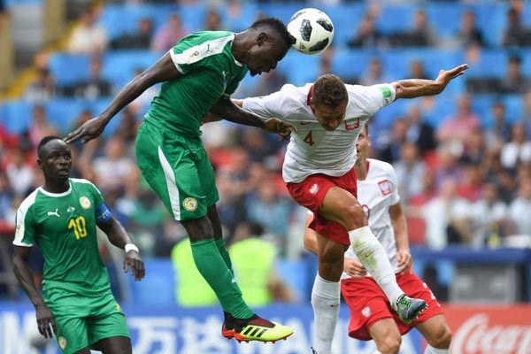 Senegal's midfielder Alfred N'Diaye (left) vies with Poland's defender Thiago Rangel Cionek during their 2018 World Cup Group H match at the Spartak Stadium in Moscow on June 19, 2018. PHOTO | PATRIK STOLLARZ | AFPAFP