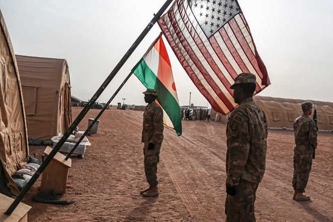 American military personnel unfurling the American and Nigerien flags at the Air Base 201 compound in Agadez. An ambush in Niger killed four American soldiers last fall, prompting an ongoing Pentagon assessment of Special Operations forces worldwide.