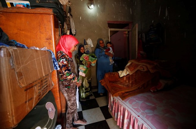 Amany Shamekh (L), 16, stands near her mother Zeinab (R) with Reem Mamdouh (C), 26, wife of Amany’s brother at their home in Awlad Serag village of Assiut Governorate, south of Cairo, Egypt, February 8, 2018. Picture taken February 8, 2018. REUTERS/Hayam Adel
