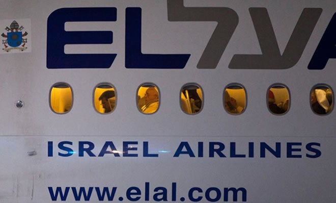 Pope Francis is seen though a window aboard an El Al aircraft as the Pontiff leaves Israel following an official departure ceremony at Ben Gurion airport near Tel Aviv, Israel, May 26, 2014. (AP Photo/Dan Balilty)