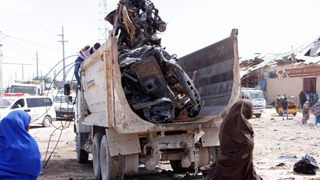A truck carries wreckage of a car used in a car bomb in Mogadishu, Somalia, Saturday, Dec. 28, 2019. A truck bomb exploded at a busy security checkpoint in Somalia's capital Saturday morning, authorities said. It was one of the deadliest attacks in Mogadishu in recent memory. (AP Photo/Farah Abdi Warsame)