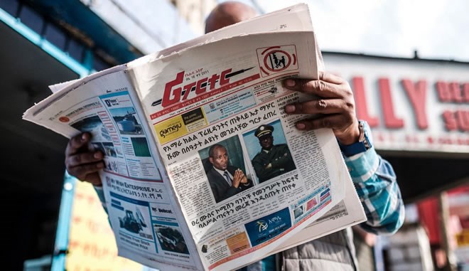 A man reads the Reporter, an Ethiopian newspaper, depicting the portraits of Ambachew Mekonnen, the president of the country’s Ahmara region, and of Gen. Seare Mekonnen, the chief of staff of the Ethiopian National Defense Force, in Addis Ababa on June 24. Eduardo Soteras/AFP/Getty Images