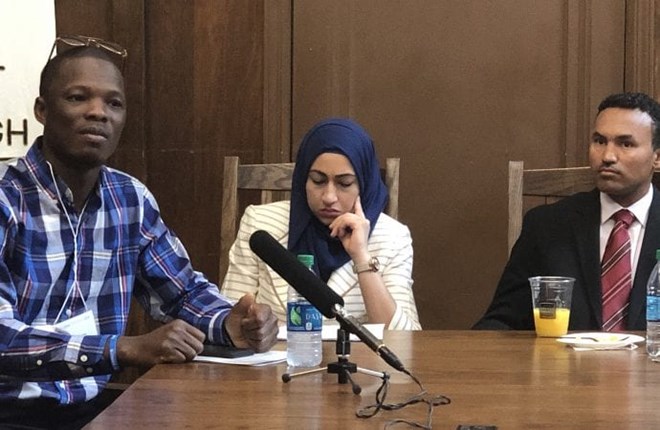 Dauda Sesay, left, along with other former refugees now resettled in the United States, speaks May 8, 2019, at the United Methodist Building in Washington about the need to increase refugee admissions to the United States.